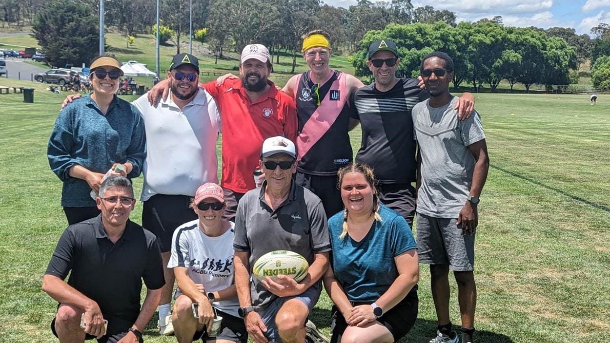 Andrew (holding ball) with AGBU Team mates after a game of interdepartmental touch football. 